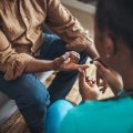 Woman taking blood sugar level of patient